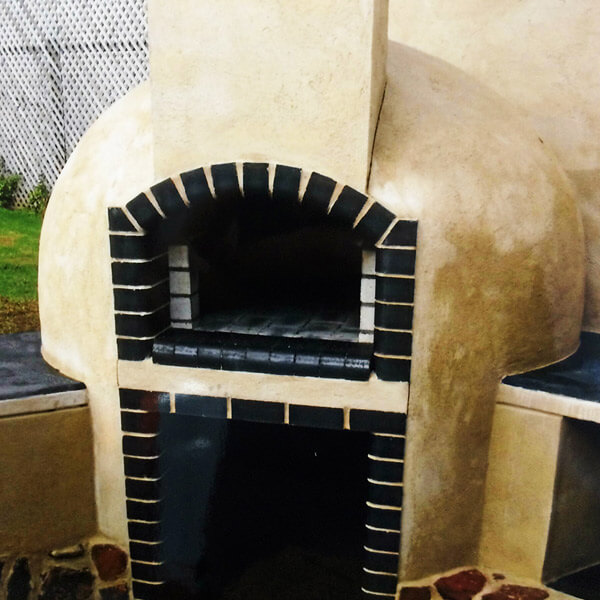 Traditional Brick Pizza Oven With White Render And Black Bricks